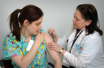Free Stock Photo: A woman receiving a vaccination shot from her doctor
