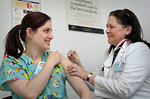 Free Stock Photo: A woman receiving a vaccination shot from her doctor