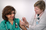 Free Stock Photo: A woman receiving a vaccination shot from her doctor