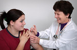 Free Stock Photo: A girl receiving a vaccination shot from her doctor