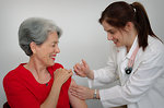 Free Stock Photo: A senior woman receiving a vaccination shot from her doctor