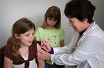 Free Stock Photo: A young girl receiving a vaccination shot from her doctor