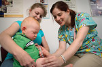 Free Stock Photo: An infant receiving a vaccination shot from his doctor