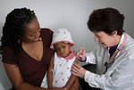 Free Stock Photo: A young girl receiving a vaccination shot from her doctor