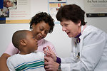 Free Stock Photo: A young African-American boy receiving a vaccination shot from his doctor