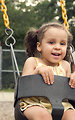 Free Stock Photo: A young girl playing on swings
