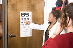 Free Stock Photo: A woman taking an eye exam with her doctor