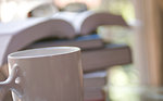Free Stock Photo: A cup of coffee with a stack of books