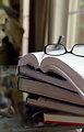 Free Stock Photo: A pair of glasses with a stack of books