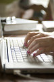Free Stock Photo: Female hands typing on a laptop keyboard