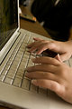 Free Stock Photo: Female hands typing on a laptop keyboard