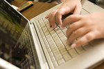 Free Stock Photo: Female hands typing on a laptop keyboard