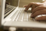 Free Stock Photo: Female hands typing on a laptop keyboard