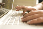 Free Stock Photo: Female hands typing on a laptop keyboard