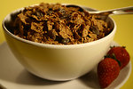 Free Stock Photo: A bowl of cereal with raisins and strawberries