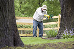 Free Stock Photo: A man spreading fertilizer on his garden