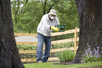 Free Stock Photo: A man spreading fertilizer on his garden