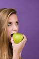 Free Stock Photo: A young woman about to bite into a green apple