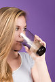 Free Stock Photo: A young woman sipping from a glass of water