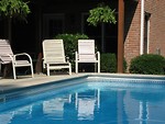 Free Stock Photo: Chairs in shade by pool