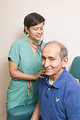 Free Stock Photo: A female doctor examining an elderly male patient