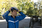 Free Stock Photo: A bicyclist putting on a safety helmet
