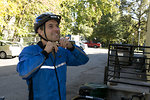 Free Stock Photo: A bicyclist putting on a safety helmet
