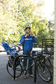 Free Stock Photo: A bicyclist putting on a safety helmet