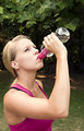 Free Stock Photo: A young woman drinking water during exercise