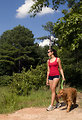 Free Stock Photo: A young woman walking her dog outdoors