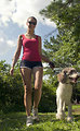 Free Stock Photo: A young woman walking her dog outdoors