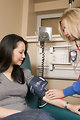 Free Stock Photo: A nurse administering a blood pressure exam to a female patient