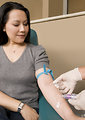 Free Stock Photo: A doctor extracting blood from a patient