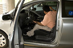 Free Stock Photo: A man in a wheelchair getting out of a car