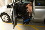 Free Stock Photo: A disabled man in a wheelchair getting out of a car