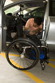 Free Stock Photo: A disabled man in a wheelchair getting out of a car