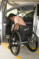 Free Stock Photo: A disabled man in a wheelchair getting out of a car