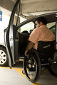 Free Stock Photo: A disabled man in a wheelchair getting out of a car