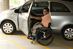 Free Stock Photo: A disabled man in a wheelchair getting out of a car