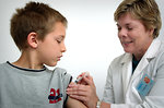 Free Stock Photo: A nurse giving a young boy a vaccination shot