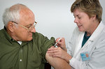 Free Stock Photo: A nurse giving a middle-aged man a vaccination shot