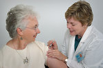 Free Stock Photo: A nurse giving a middle-aged woman a vaccination shot