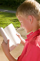 Free Stock Photo: A boy reading a book