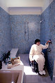 Free Stock Photo: A woman in a wheelchair getting into a shower