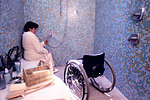 Free Stock Photo: A woman in a wheelchair getting into a shower