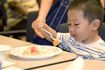 Free Stock Photo: A small child eating fruit
