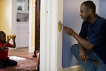 Free Stock Photo: A man repairing a door frame in his home