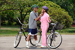 Free Stock Photo: An African-American couple preparing to ride bikes