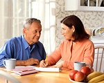 Free Stock Photo: A woman and older man sitting at a table