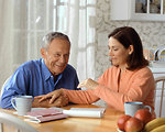 Free Stock Photo: A woman and older man sitting at a table